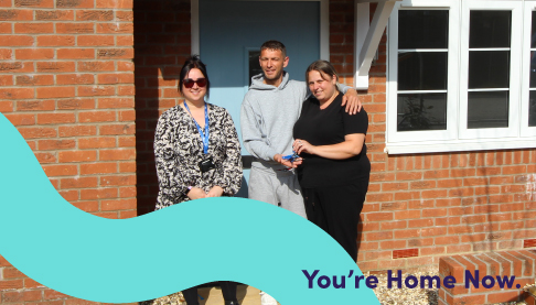 Neighbourhood Manager Anita with two tenants outside their new home.